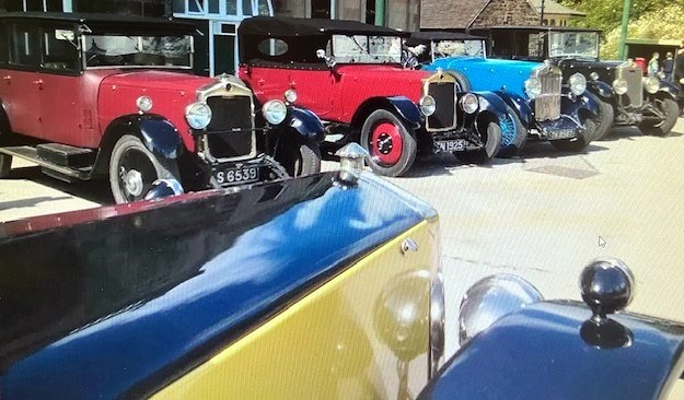 Lanchester motor cars parked together at a country event